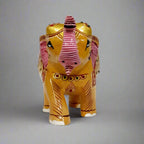 Elegant wooden elephant sculpture with raised trunk for good fortune, detailed embossed painting, and miniature elephant artwork on the side.