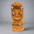 Hand-carved wooden Ganesh statue with umbrella detailing, symbolizing protection and prosperity