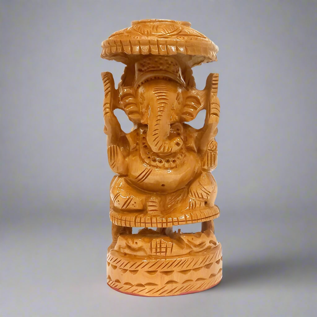 Hand-carved wooden Ganesh statue with umbrella detailing, symbolizing protection and prosperity