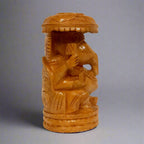 Traditional yet modern round wooden Ganesha idol crowned with an umbrella, representing remover of obstacles