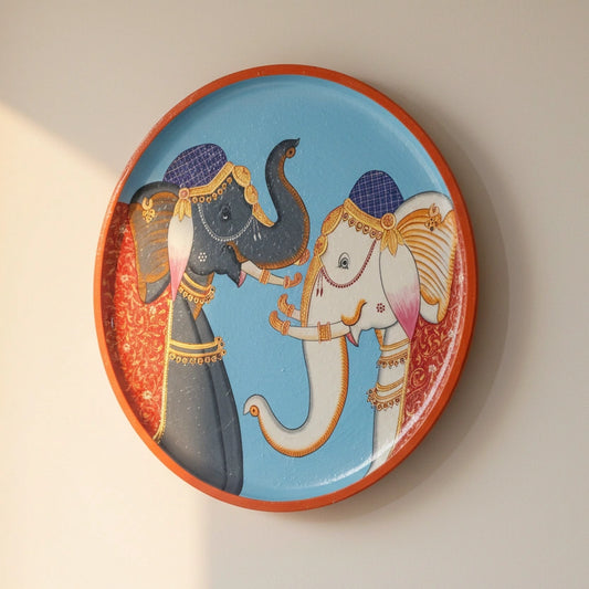 A hand-painted wooden wall medallion featuring a majestic caparisoned elephant in traditional Indian regalia, centered on a premium timber base.