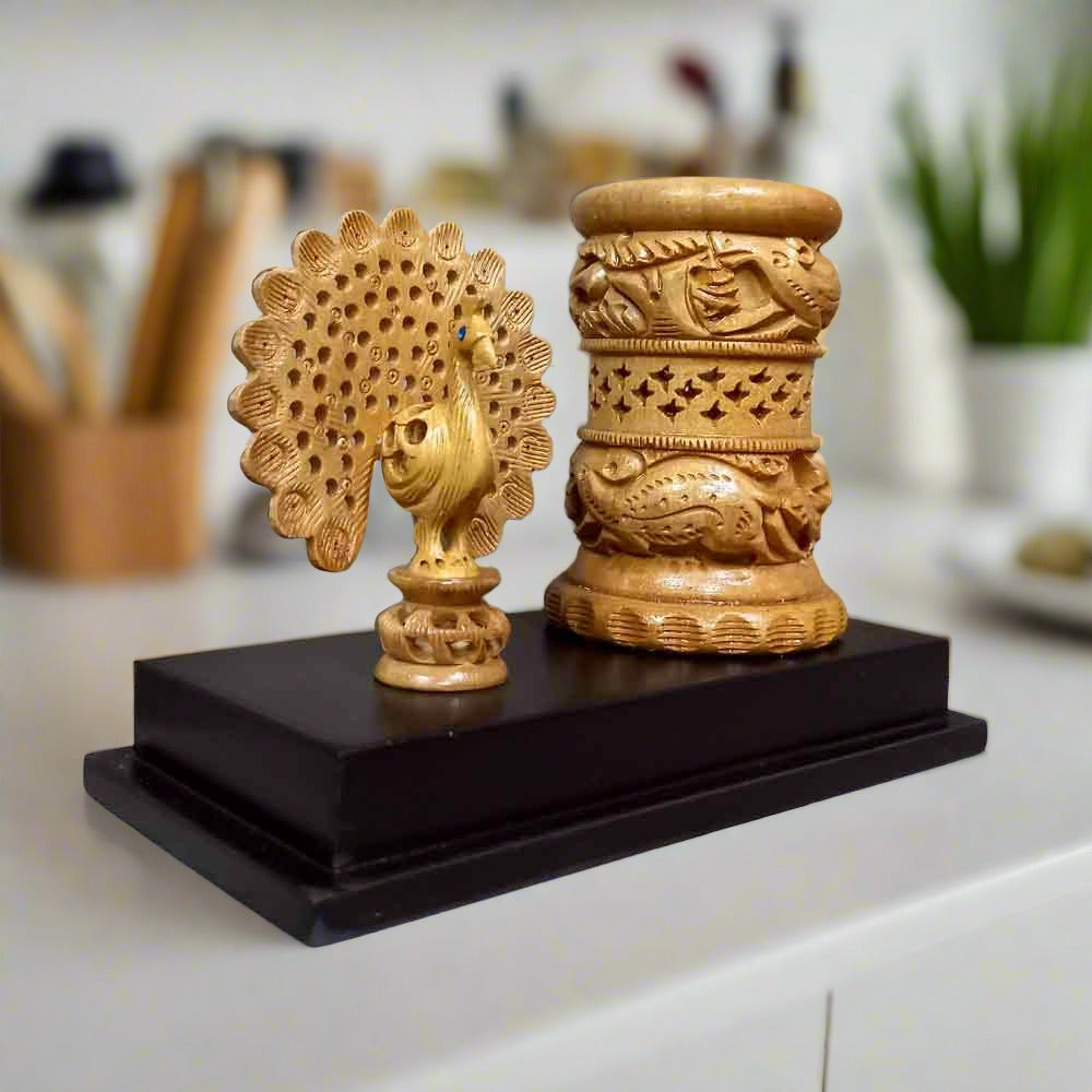 Hand-carved wooden pen stand with intricate peacock detailing, traditional handicraft