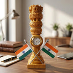 Front view of a carved wooden Ashok Stambh with a round clock and two crossed Indian flags on a study table