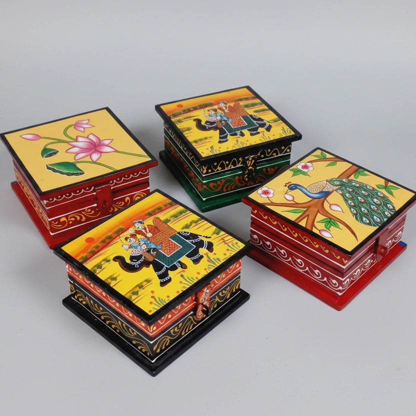 Various assorted hand-painted designs on small wooden trinket boxes, highlighting the one-of-a-kind artistry of each piece.