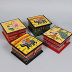 Various assorted hand-painted designs on small wooden trinket boxes, highlighting the one-of-a-kind artistry of each piece.