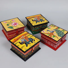 Various assorted hand-painted designs on small wooden trinket boxes, highlighting the one-of-a-kind artistry of each piece.