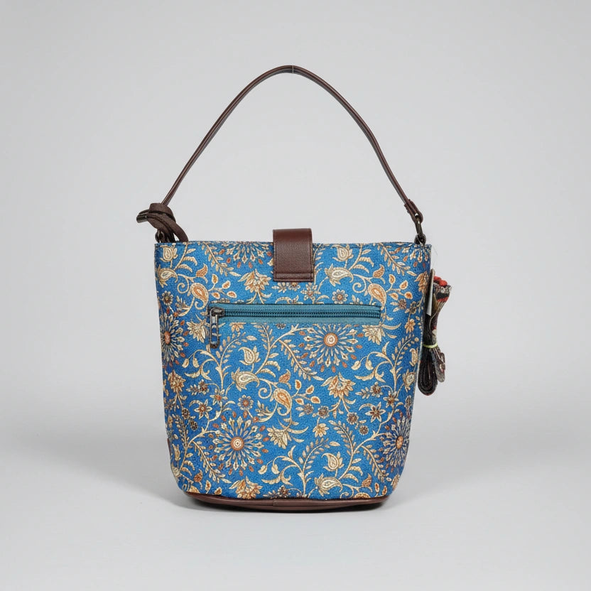 The back side of a floral crossbody bag showing a secure horizontal zipper pocket for phone storage.