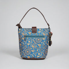 The back side of a floral crossbody bag showing a secure horizontal zipper pocket for phone storage.