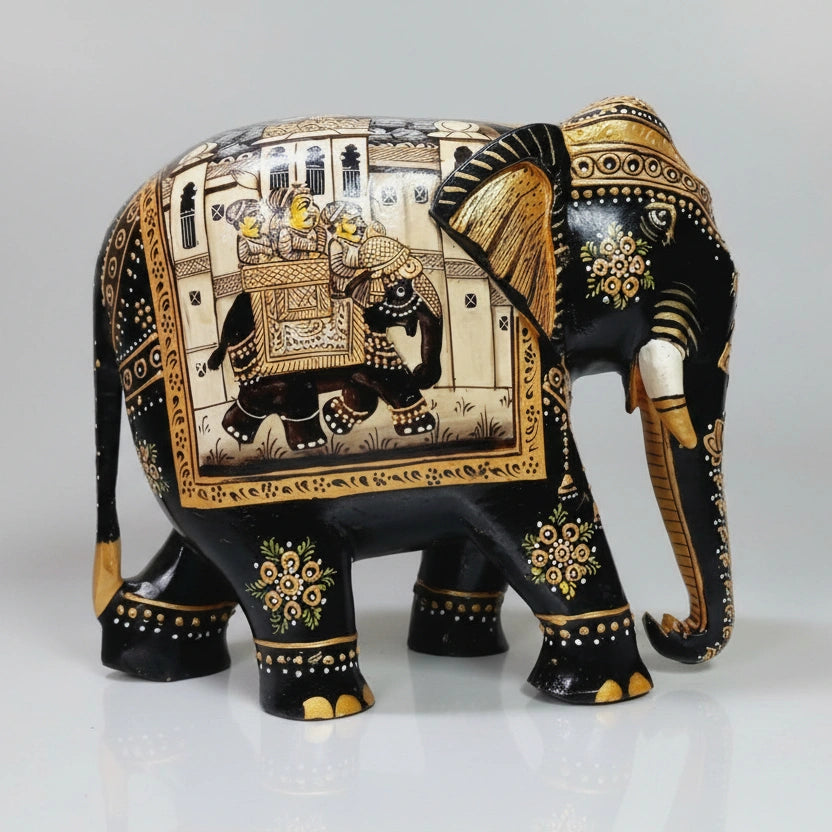 Closeup of miniature painting on black elephant figurine with golden and white detailing
