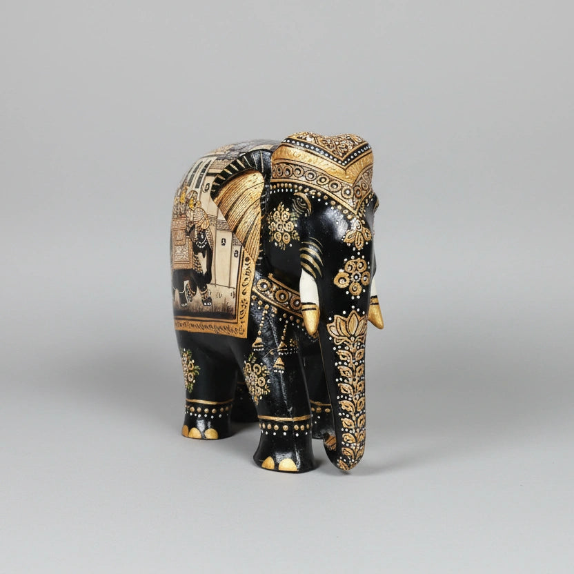 Wooden handcrafted black elephant figurine side angle showing golden highlights