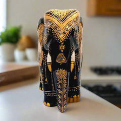 A decorative piece of two black elephants with detailed miniature paintings on their bodies, for a living room.