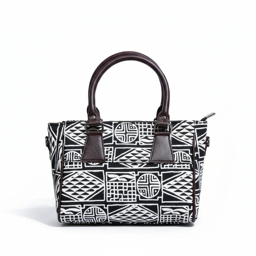 Front view of a black fabric sling bag featuring a PU leather top handle.