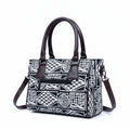 Back view showing the secure exterior zip pocket on the black 10x8 handbag.