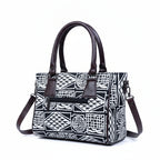 Back view showing the secure exterior zip pocket on the black 10x8 handbag.