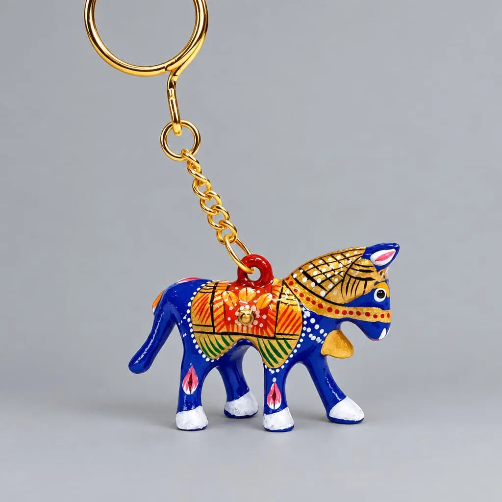 Blue Meenakari horse keychain with multicoloured saddle detailing and a gold-tone chain and key ring