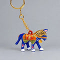 Blue Meenakari horse keychain with multicoloured saddle detailing and a gold-tone chain and key ring