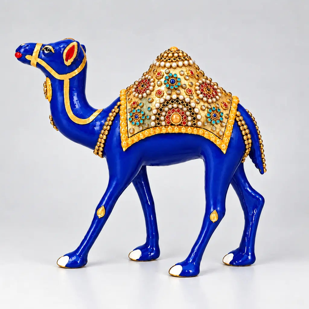 Side view of a blue metal Rajasthani camel with a gold-toned saddle decorated with colourful floral stone patterns