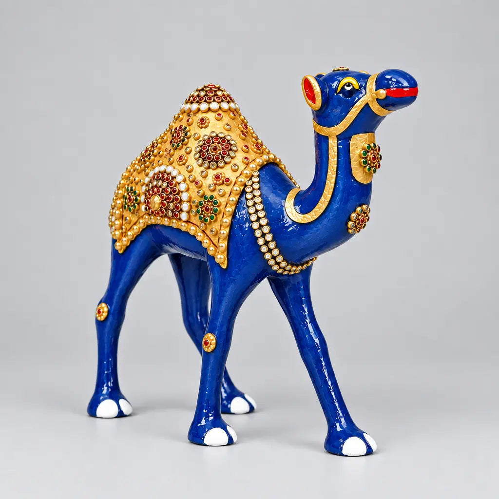 Blue metal Rajasthani camel showpiece with a gold-toned saddle and colourful stone work, viewed at an angle
