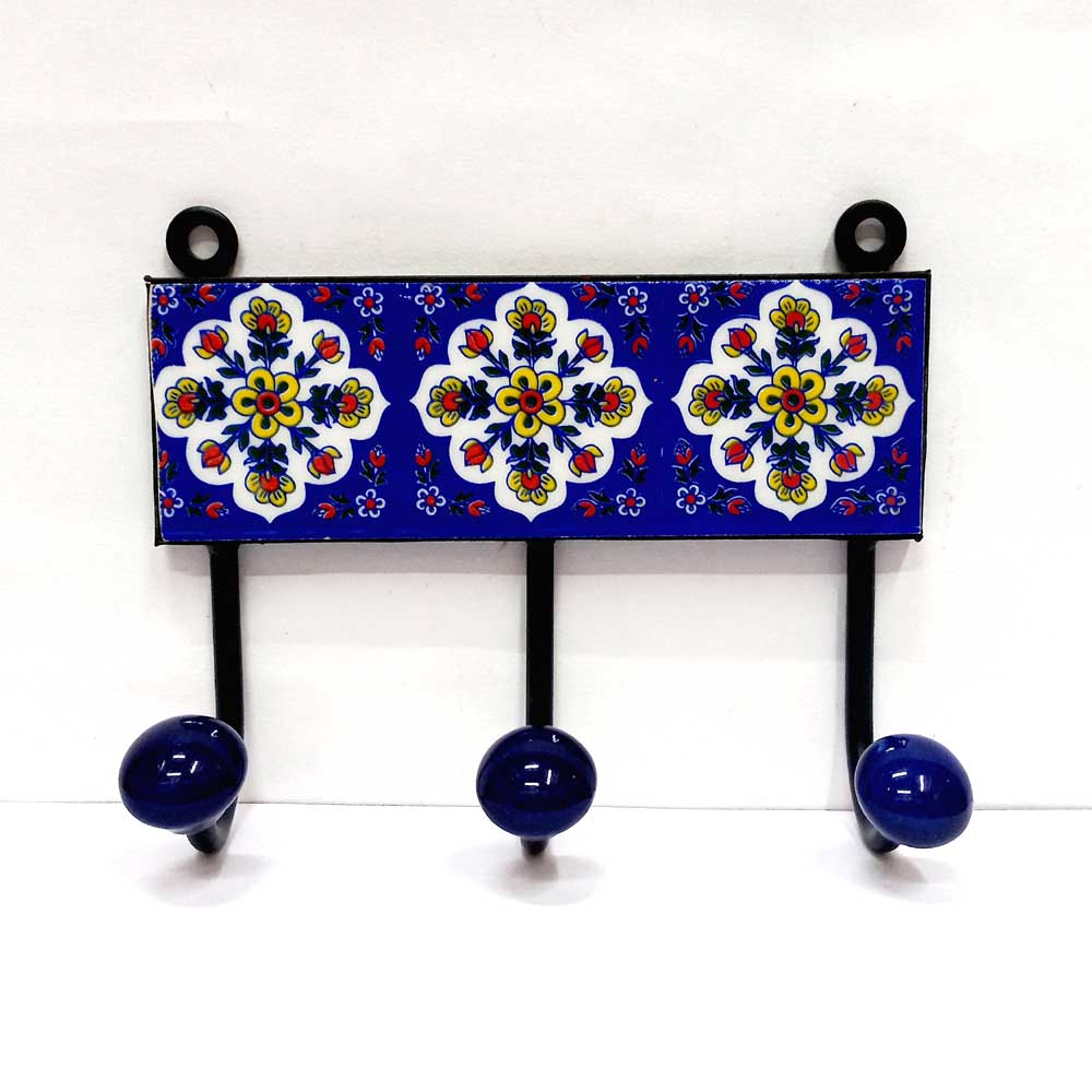 A decorative Blue Pottery 3-hook key holder, a vibrant piece for home decor.