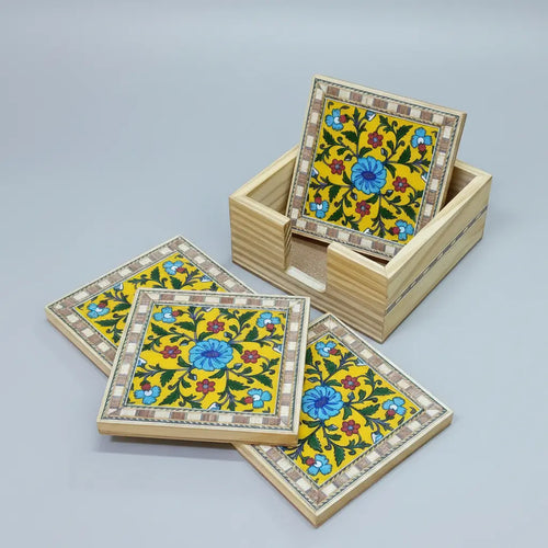 Close-up of Blue Pottery tile coaster showing vibrant floral motif and inlaid border detail