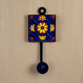 A decorative Blue Pottery wall hook that can be used as a cloth hanger.