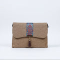 Front view of a 10x8 inch boho crossbody bag with leather tassel and floral strap