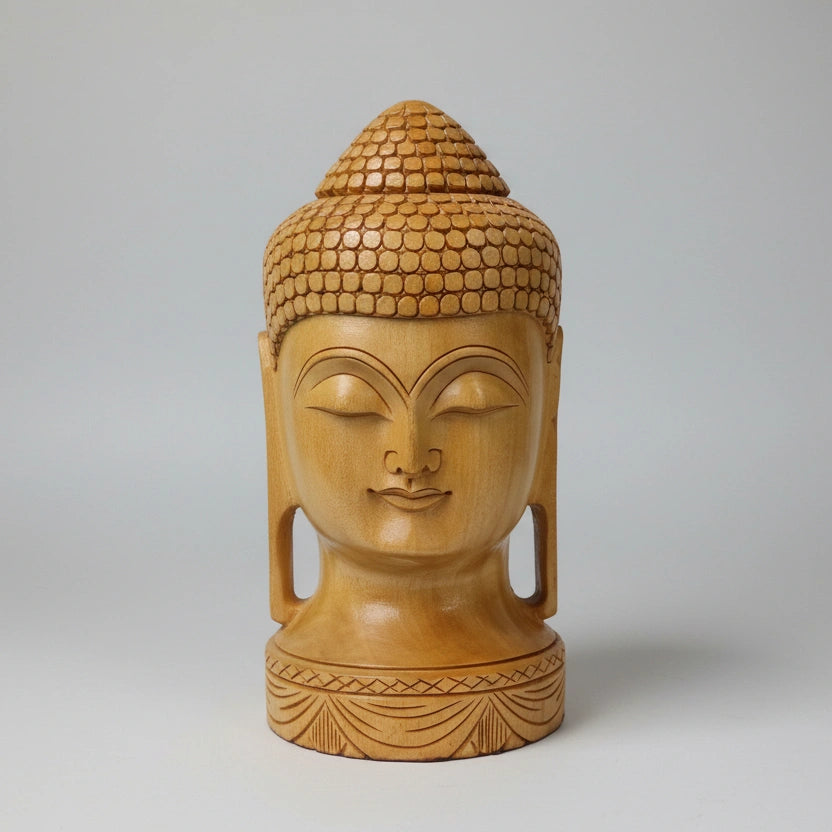 Close-up of the traditional Ushnisha topknot and textured hair pattern hand-carved by Jaipur artisans on a solid wood Buddha idol.