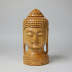 Close-up of the traditional Ushnisha topknot and textured hair pattern hand-carved by Jaipur artisans on a solid wood Buddha idol.