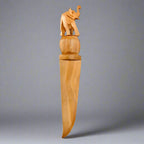 Close up view of the intricate hand carving and smooth polished finish on the wooden elephant handle.