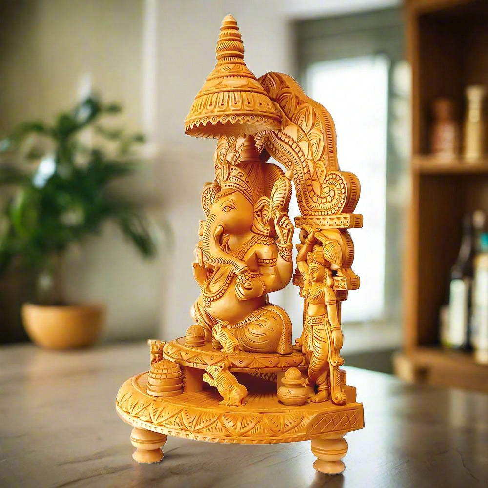 A beautifully carved wood Ganesh idol giving blessings and holding laddoos, with Riddhi and Siddhi on either side.