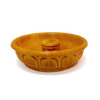 A carved wooden dhoop holder for incense cones, ideal for meditation and yoga.