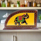 A hand-carved wooden tissue box cover with a detailed elephant design. 