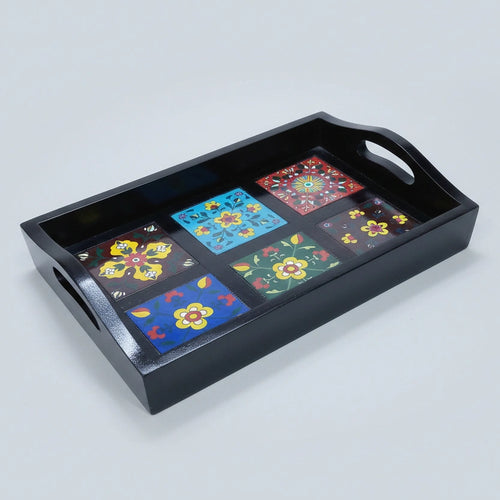Close-up of the fired ceramic tile inserts flush-mounted into a solid wood frame, highlighting the vibrant colors and floral motifs.