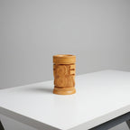 A perfectly round 6cm diameter wooden pen stand showing the iconic Indian currency mark in a minimalist, modern style.
