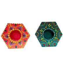 A set of two colorful hand-painted wood candle holders for home decoration.