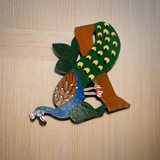 Decorative wooden fridge magnet featuring a colorful peacock design