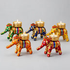 Five cotton elephant tealight holders in assorted colours with lace trim, sequins and metal mesh candle cups