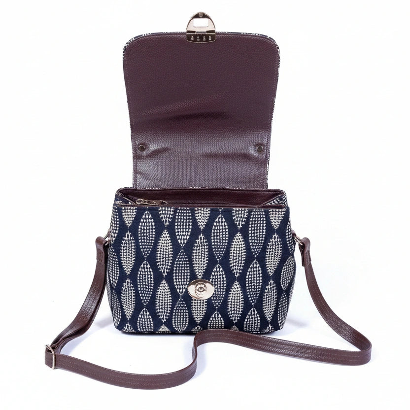 View of three zip compartments on an ethnic cotton bag with two main zips