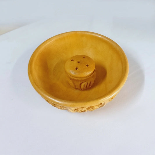 A decorative agarbatti stand with detailed wood carving for a pooja room.