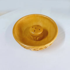 A decorative agarbatti stand with detailed wood carving for a pooja room.