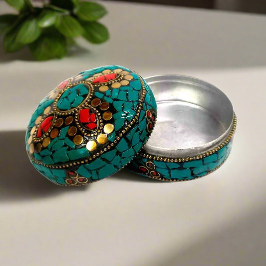 Decorative sindoor storage box featuring detailed craftsmanship