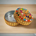 A decorative lac box with a hand-art design, perfect for home decor.