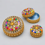 Decorative lac box set with one box open to show the metal interior and two closed boxes with colourful floral lid decorations.