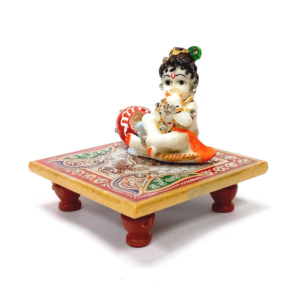 Decorative marble Krishna idol seated on a chowki, Rajasthani handicraft.