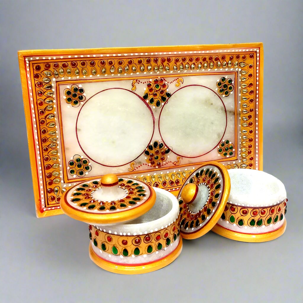 A decorative marble tray and container set, perfect for serving or display.