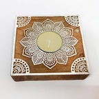 A decorative wooden candle stand, ideal for a tabletop or mantelpiece.