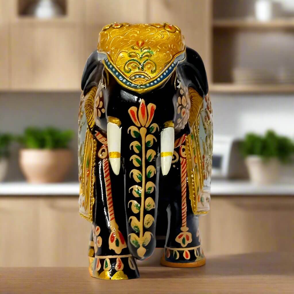 Decorative wooden elephant figurine with golden emboss and floral red-green art