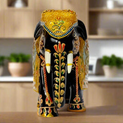 Decorative wooden elephant figurine with golden emboss and floral red-green art