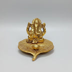 Close-up view of the intricate leaf textures and Lord Ganesha's features in a long-lasting golden polish.