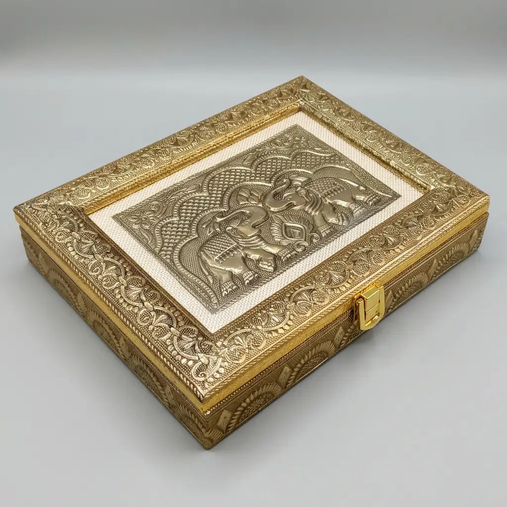 Angled view of gold-tone wooden dry fruit box with two elephant motifs, an ivory-tone border and front clasp